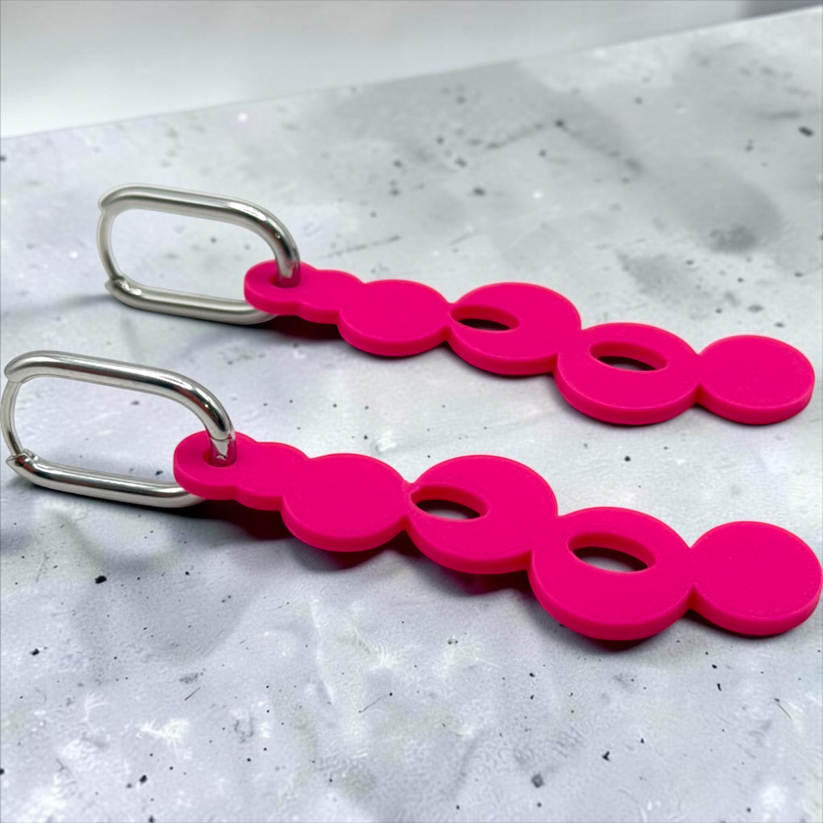 RISITEC - Timeless By Design Bubble Line Ohrringe in Pink mit langen, verbundenen Kreisen und ovalen Edelstahl-Creolen