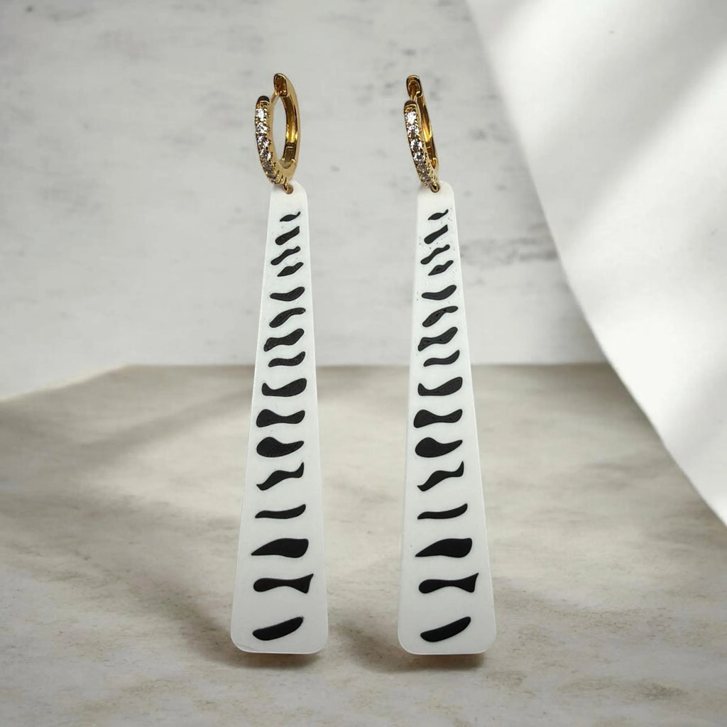 RISITEC - Timeless By Design Zebra Line long drop earrings with black and white patterns and 24K gold-plated hoops.
